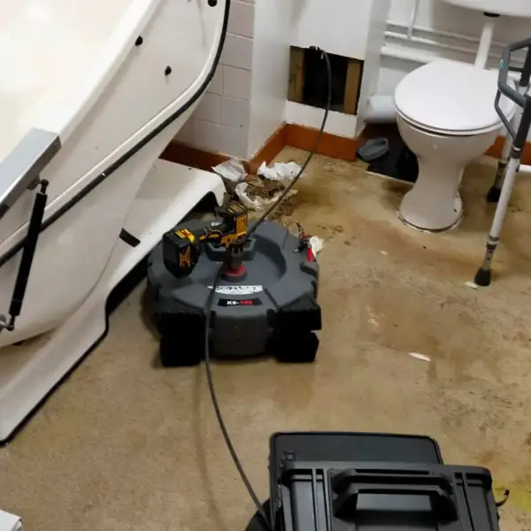 Drain machine in a commercial washroom clearing a blocked internal stack
