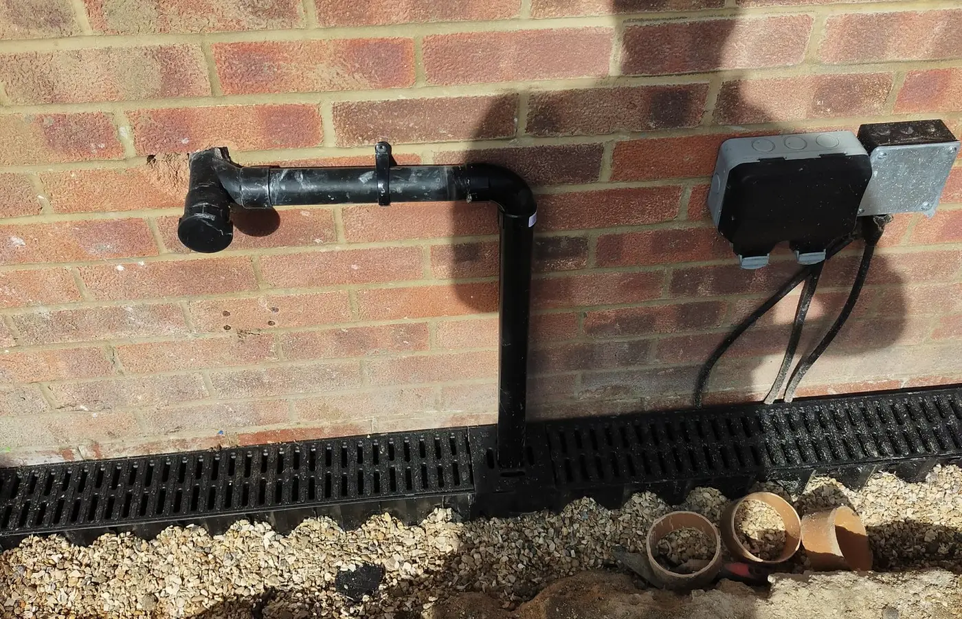New ACO channel drain laid along a house wall