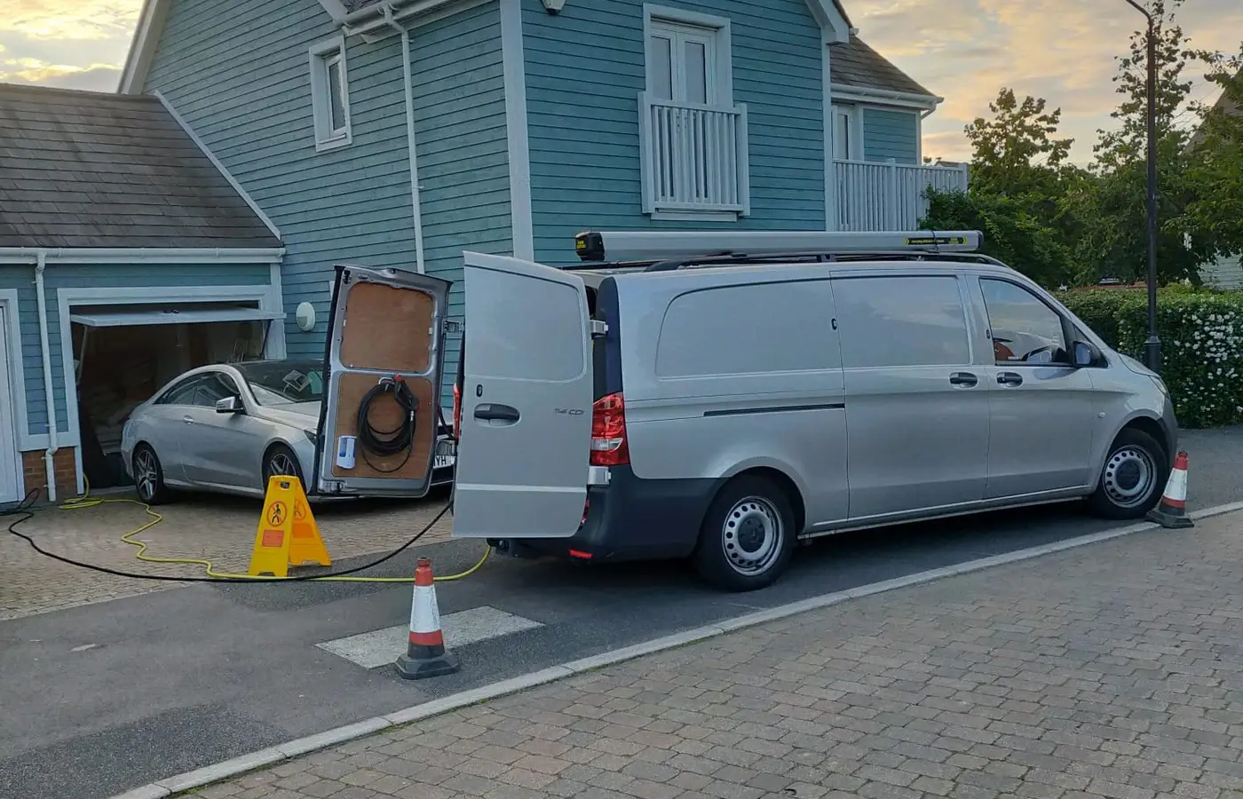 Van with jetting kit parked outside a house to clear a blocked internal stack